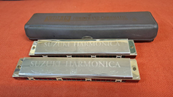 Three vintage Suzuki harmonica mouth organs one being a multi scale.