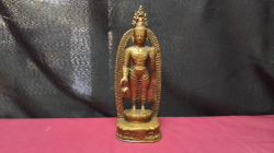 A Brass standing Buddha stood by an Arch with a copper base. 
H25vW8cm.