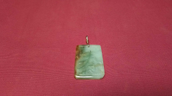 A Jade pendant with a gold fitting 