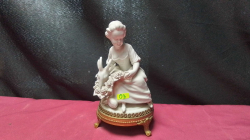 A bisque figure of a girl ander on a brass stand.
H10 W17cm.