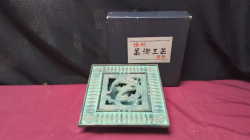 A Japanese cast metal Ashtray featuring a raised dragon motif with verdigris and green patina in original box.