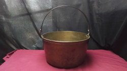 An extremely heavy brass jam pot with a metal handle. 
35x40cm.