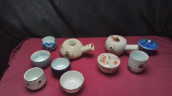 An assortment of vintage Chinese items, Tea Pots, 6 cups and 2 sugar bowls ,marked at base.