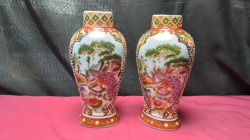 A Pair of Lovely Chinese 10 inch porcelain Vases in very good condition Depicting bird of paradise nicely Gilded an Embossed stamped to base .