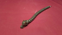  silver tonedDragon bracelet with a detailed Dragons head with gemstone accents on the eyes and a flexible large segmented like body

