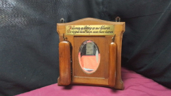 A Small clotues brush set wall hanging with a Bevel mirror.28x28cm.