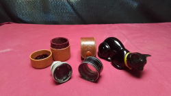 An Avon cat and two camera lens 