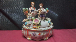 A Goriouse antique Meissen 19 century bonbonniere & lid made by Ritzenhoff becker decorated with girl & boy gardening lot of flowers Absolutely mint condition 16cm hight 14 cm width stamped to base