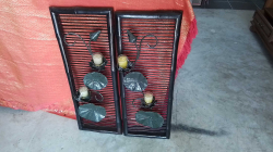 Wall Candle holder  Wrought Iron lot motif on black wood frame. 