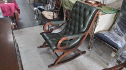 Chesterfield style rocking chair with deep button tufting in olive green leather,.
