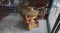 Decorative hall table with Three carved praying figures with half moon glass top 