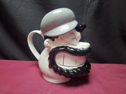 A doulton Paul cardew 2001.tea pot featuring brutus popeyes riual.
H22xW13cm.
